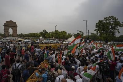 Indian wrestlers hold candlelight march demanding arrest of sports official for sexual abuse