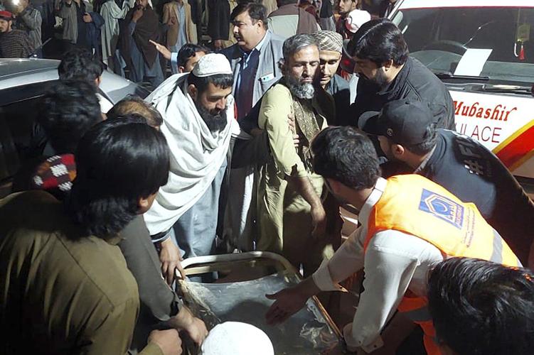 Pakistanis mourn 18 people, including 5 soldiers, killed in a twin suicide bombing at an army base