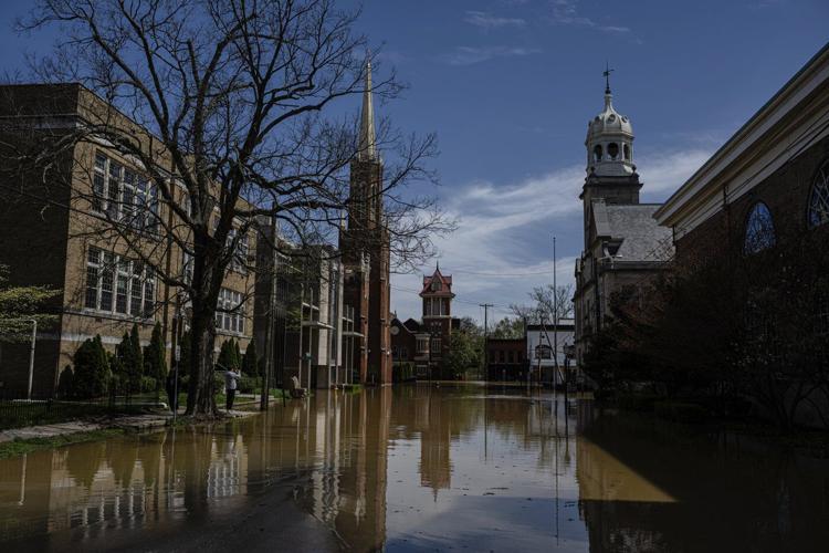 Kentucky watches for surging rivers to recede so widespread cleanup can begin