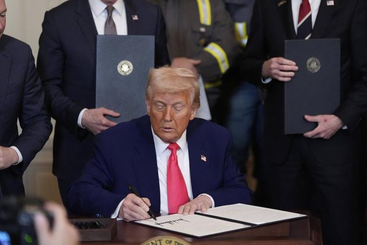 The Latest: Trump signs executive orders to boost coal