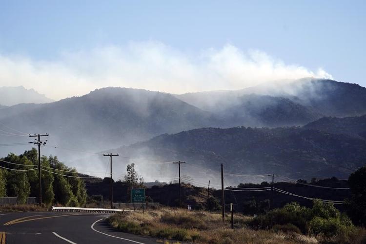 Firefighters battling to contain Southern California wildfire though many homes remain threatened