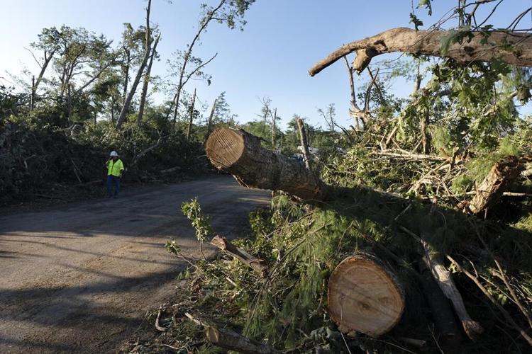 Rare New England tornado lifts car from a highway as strong storms damage homes and flood roads