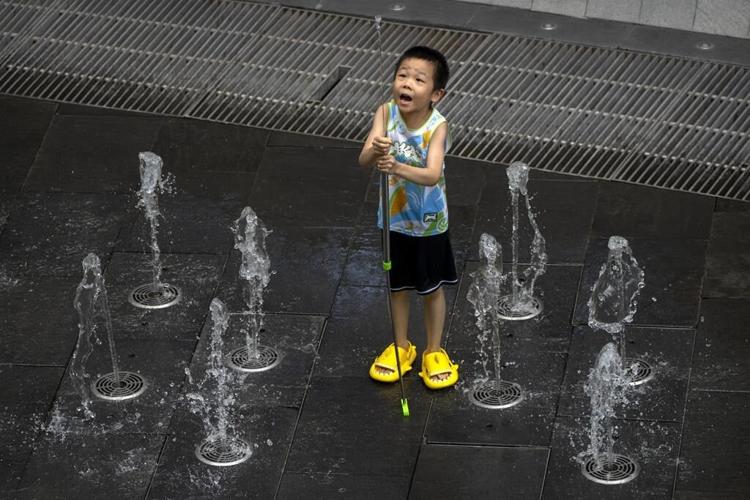Flooding displaces 10,000 around China as Beijing gets a slight respite from an extreme heat wave
