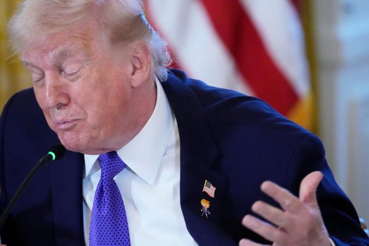 Trump wears a new 'Happy Trump' lapel pin, but insists he's never happy