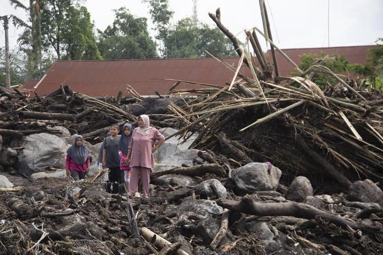 Indonesian rescuers search through rivers and rubble after flash floods that killed at least 50