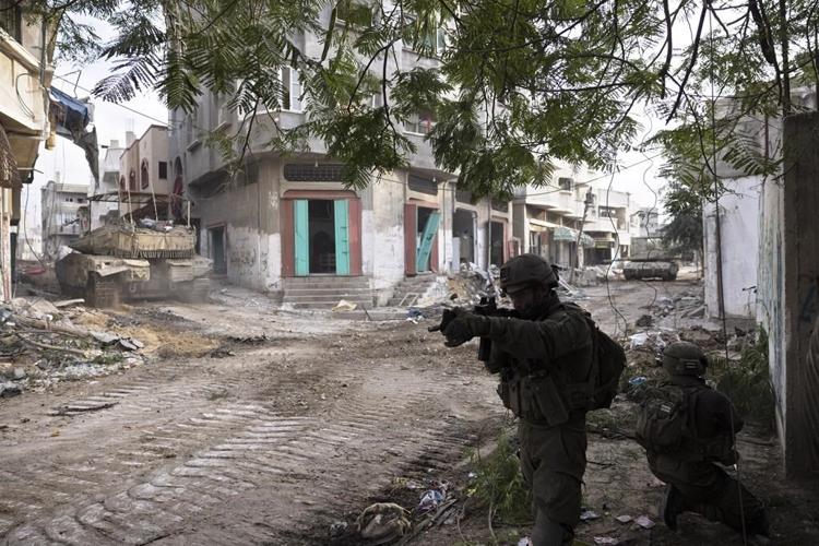 Israel battles militants in Gaza's main cities, with civilians still trapped in the crossfire
