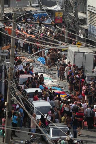 Brazilians in a Rio favela line up bodies after the city's deadliest police raid