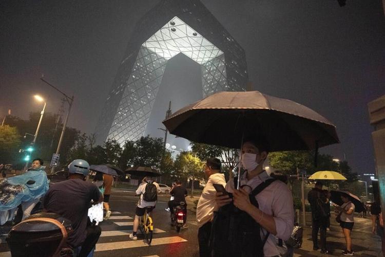 A mudslide kills at least 2 in China while rain from Khanun cancels some trains in the northeast