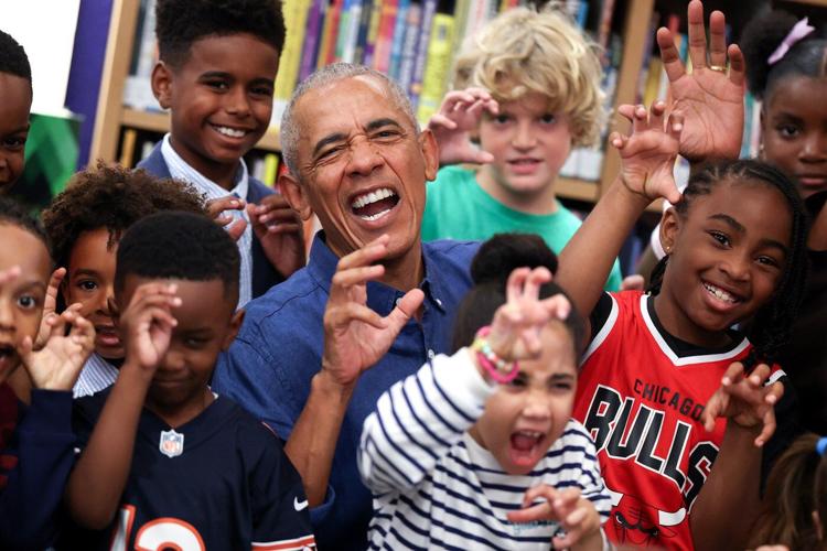 Barack and Michelle Obama surprise first visitors to newly opened presidential center