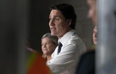 Trudeau appears at news conference with bandage after bumping head