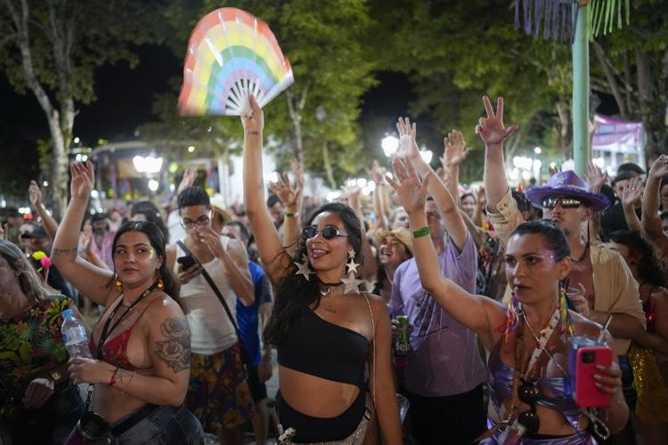 Families and revelers party side-by-side in a traditional Carnival in Sao Paulo's countryside
