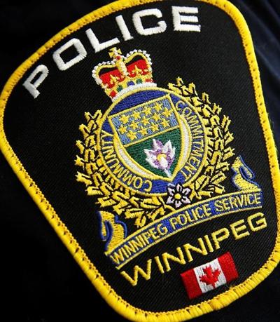 Signs calling for police to search landfills taped to Winnipeg police headquarters