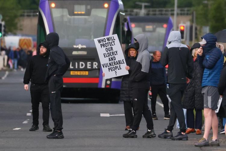 UK leaders call for calm after a Sudanese suspect is arrested in a Belfast street stabbing
