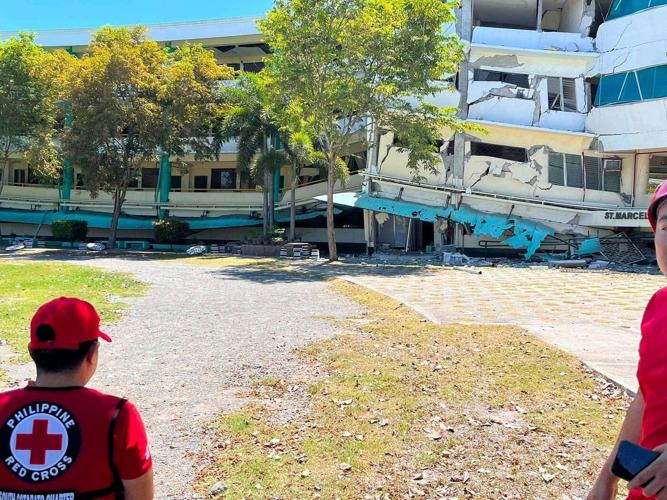 A 7.8 magnitude quake in the Philippines kills at least 16, fells buildings and sets off a tsunami
