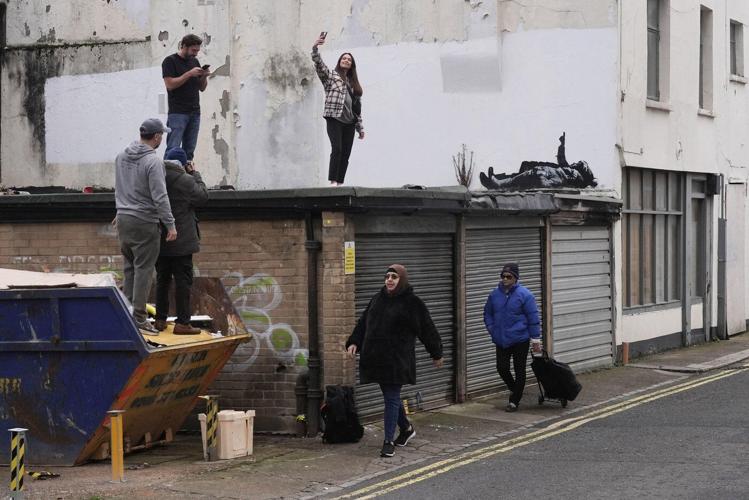 Banksy unveils new art in London following speculation over murals depicting stargazing figures