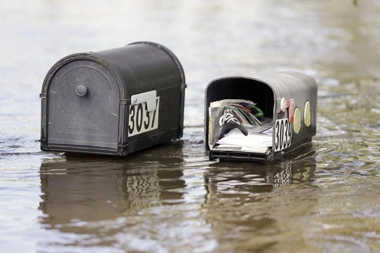 Residents slog through flooded streets, clear debris after Hurricane Milton tore through Florida