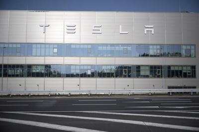 Production at Tesla's plant in Germany is halted after a power outage. Officials suspect arson
