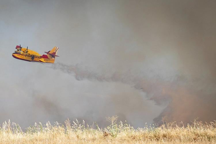 An uncontrolled wildfire sends a cloud of smoke over Spain's capital