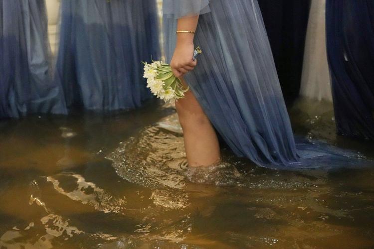 Photos show a Filipino couple walking down a flooded aisle on their wedding day