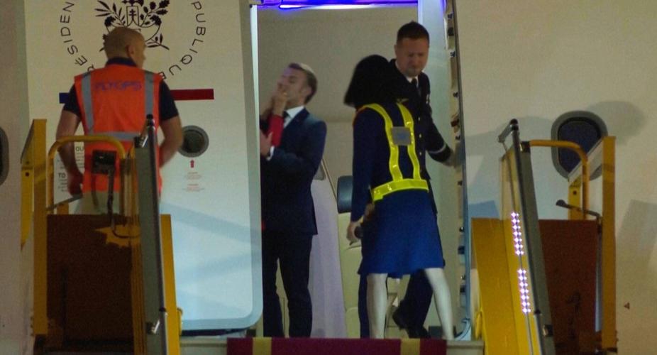 France's first lady seems to push her husband as they land in Vietnam. He says they were joking