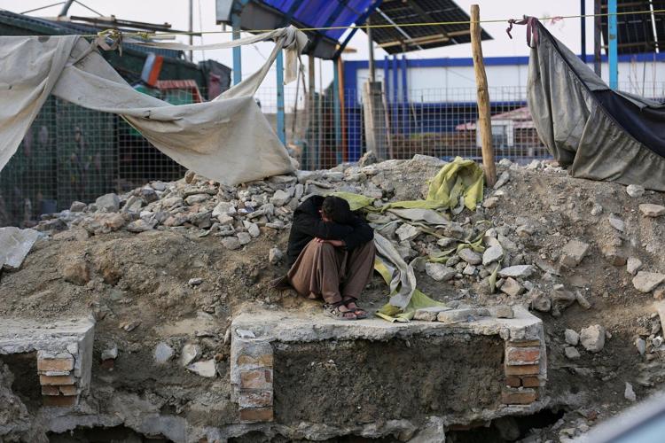 Rescue crews race through rubble after a deadly Kabul airstrike, in photos
