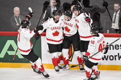 MacKinnon has three points, Canada finishes first in Group A with 5-3 win over Sweden