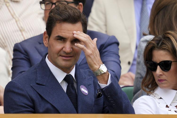 Roger Federer sits in Wimbledon's Royal Box to watch rival Novak Djokovic win