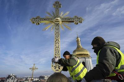 Authorities return restored golden crosses to the domes of Kyiv's St Sophia Cathedral