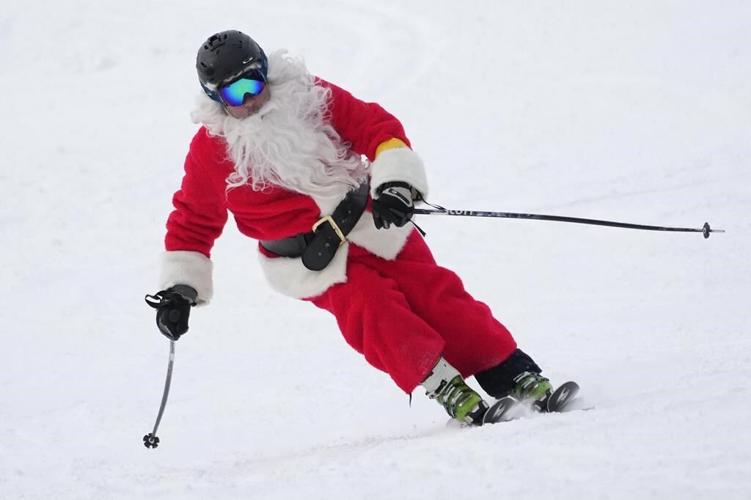 It’s all downhill for 300 skiing Santas, a Grinch and a tree