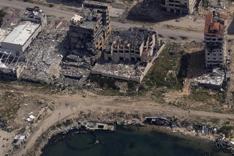 From a US military plane, airdrops bring small doses of aid to Gaza, levelled by war