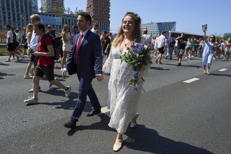 Couples tie the knot during a festival on an Amsterdam ring road