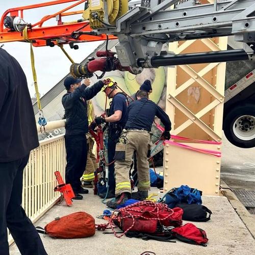 A bridge where firefighters rescued the driver of a semi dangling over the Ohio River remains closed