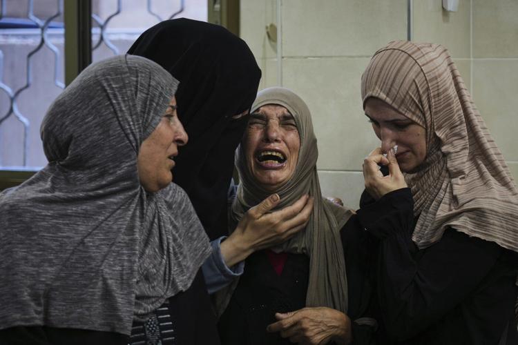 Photos show Palestinians mourning after people were killed in Israeli strikes