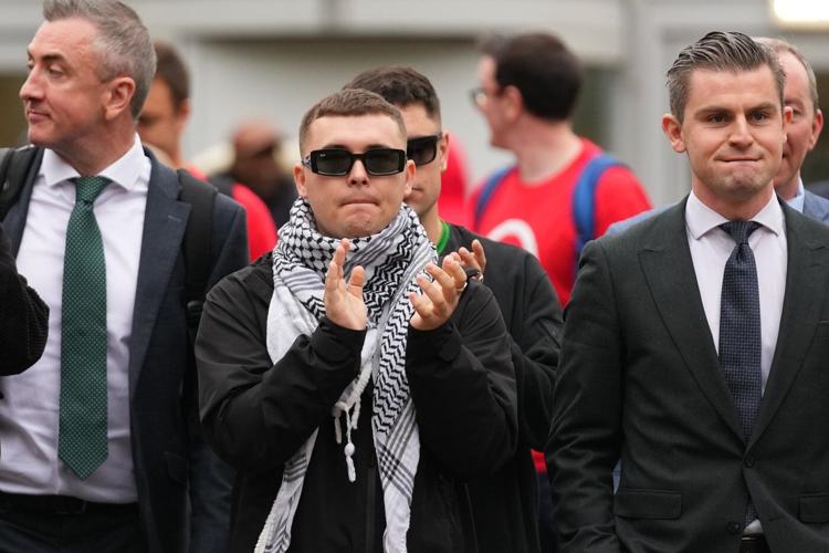 A British court throws out terror-related charge against Irish-language hip-hop group Kneecap member