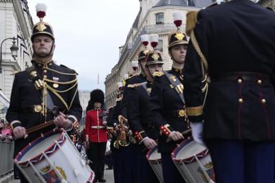 British, French troops march in historic joint parades in London and Paris in a show of solidarity