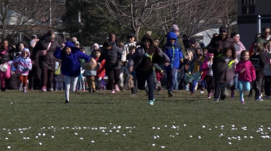 Children race to collect marshmallows dropped from a helicopter at a Detroit-area park