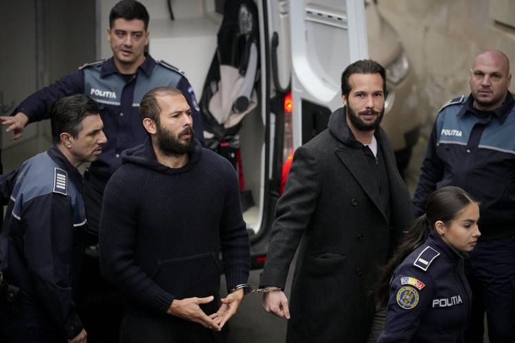 Influencer Tate brothers, who face human trafficking charges in Romania, arrive in the US