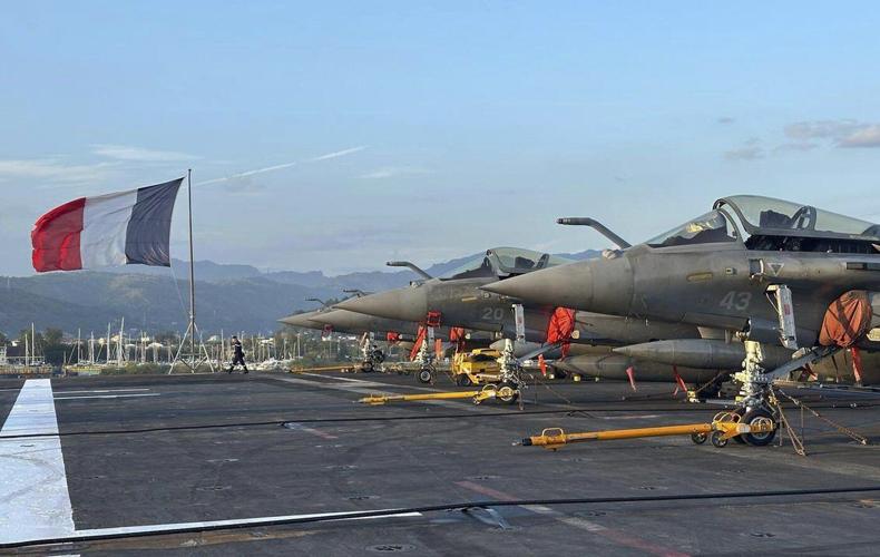 French aircraft carrier stages combat drills with Filipinos in disputed sea and visits Philippines
