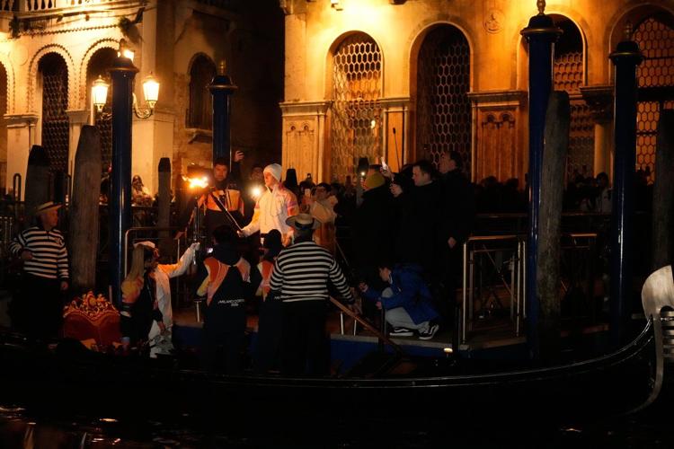 Olympic flame makes historic passage down Venice's Grand Canal