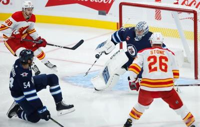 Jets dominate Flames behind Rittich's 37 saves, four second-period goals in 5-0 win