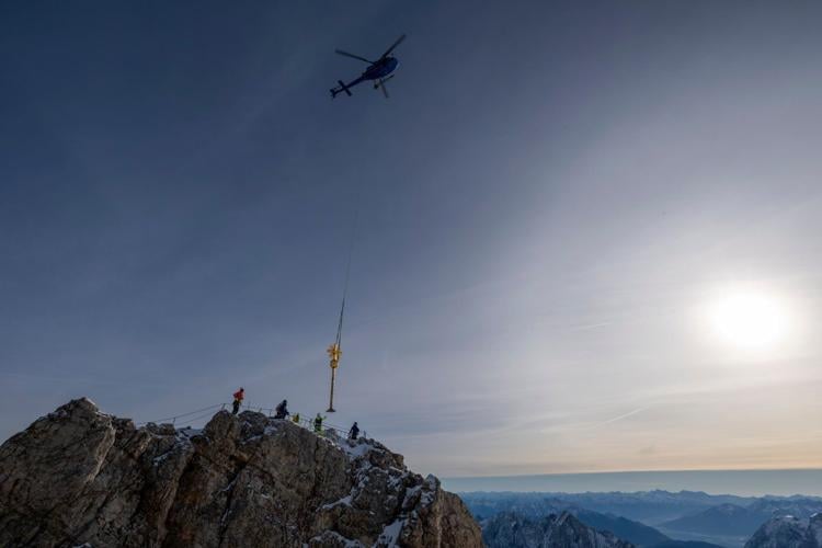 The gilded cross on Germany's highest peak has too many stickers. Now it's being restored
