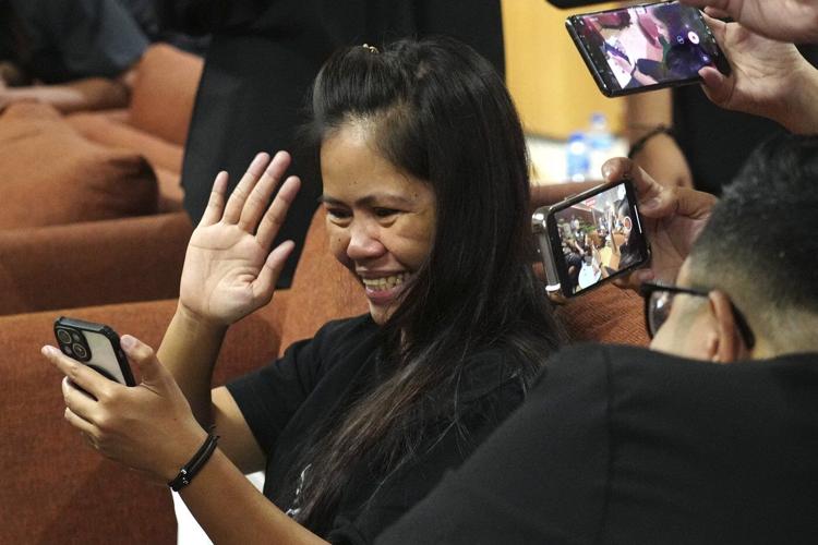Filipina who won a last-minute reprieve from an Indonesian firing squad is returning home