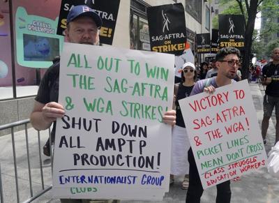 Movie and TV stars join picket lines in fight over the future of Hollywood