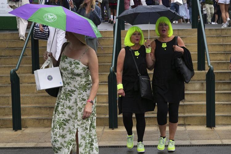 Photos show the rain on Day 3 after the Wimbledon heatwave