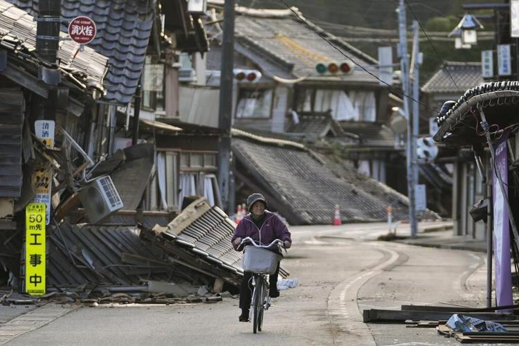 Rescuers race against time in search for survivors in Japan after powerful quakes leave 62 dead