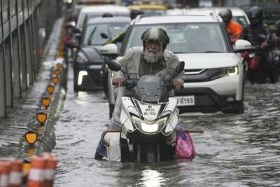 Record rains bring Mumbai to a standstill, in photos