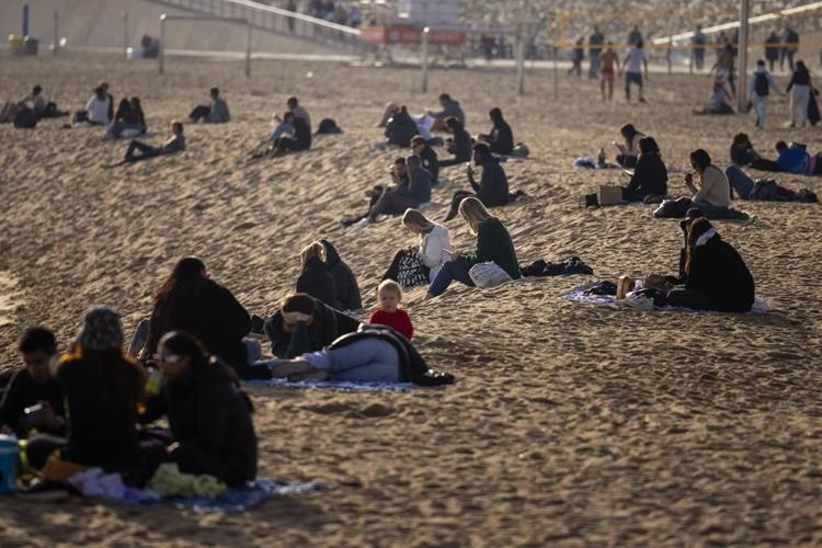 People take to the beach as a winter heat wave hits much of Spain