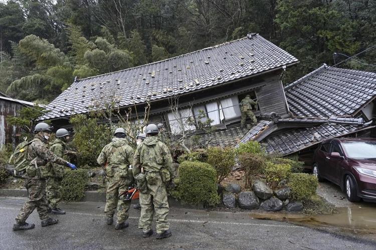 Rescuers race against time in search for survivors in Japan after powerful quakes leave 62 dead