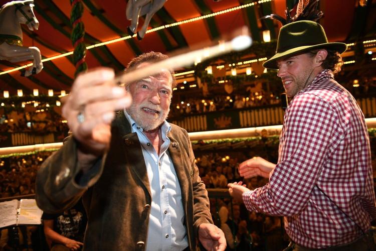 Schwarzenegger directs a band in a beer tent at Munich's Oktoberfest