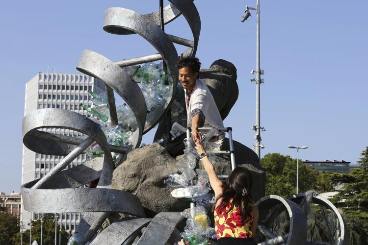 Artist drowns sculpture in plastic waste in front of the UN during plastic pollution treaty talks